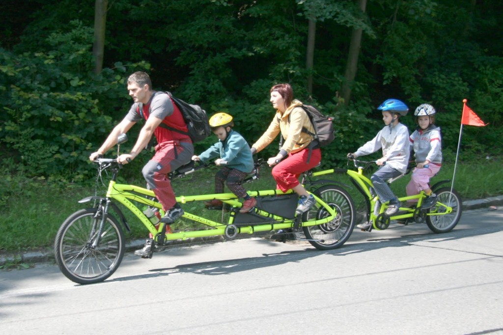 an amazingly long bike with an attachment bike for two children with an electric motor