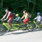 an amazingly long bike with an attachment bike for two children with an electric motor